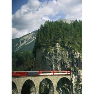 Train Passes into a Tunnel in the Mountains of Switzerland Premium 