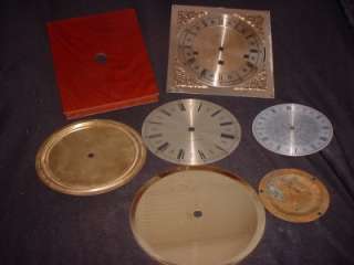 Featured are three clock dials, pans and one cherry colored clock 