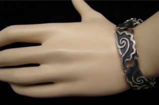 This hand wrought bracelet is deeply carved, with a fabulous conch 