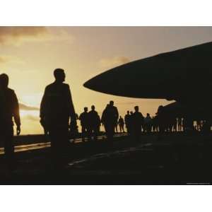  Silhouetted Military Personnel on an Aircraft Carrier at 