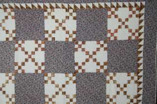   quilt is hand pieced and hand quilted, with a nice sawtooth border