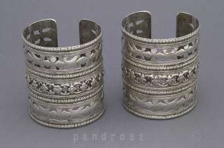 pair of nice silver bracelets with open work floral design.