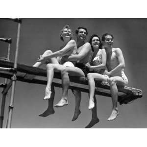 Two Couples in Bathing Suits Sitting on Diving Board Photographic 